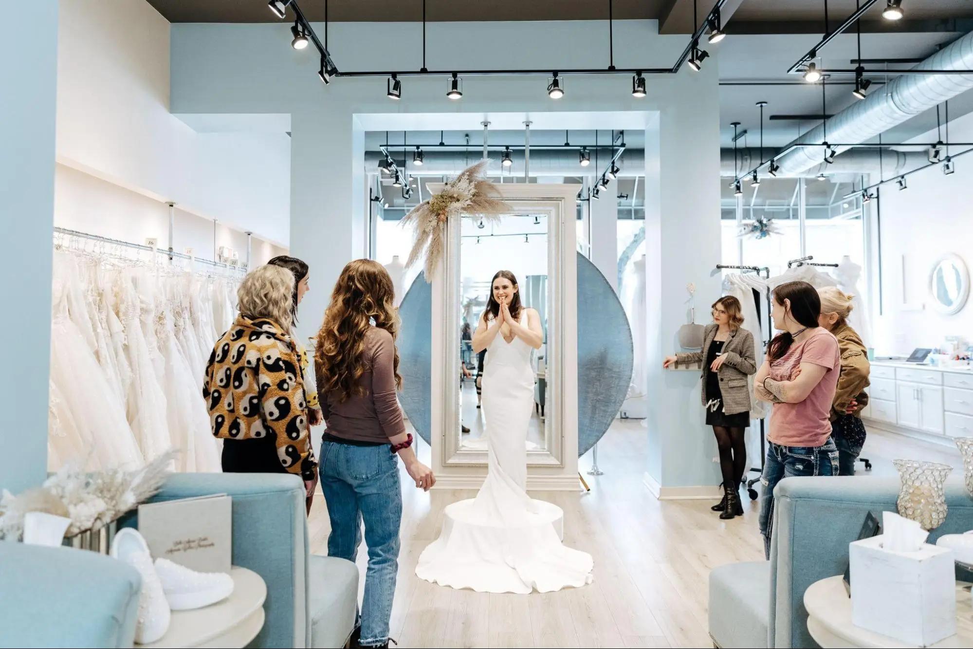 Belle Amour bridal experience. Bride trying on a wedding dress.
