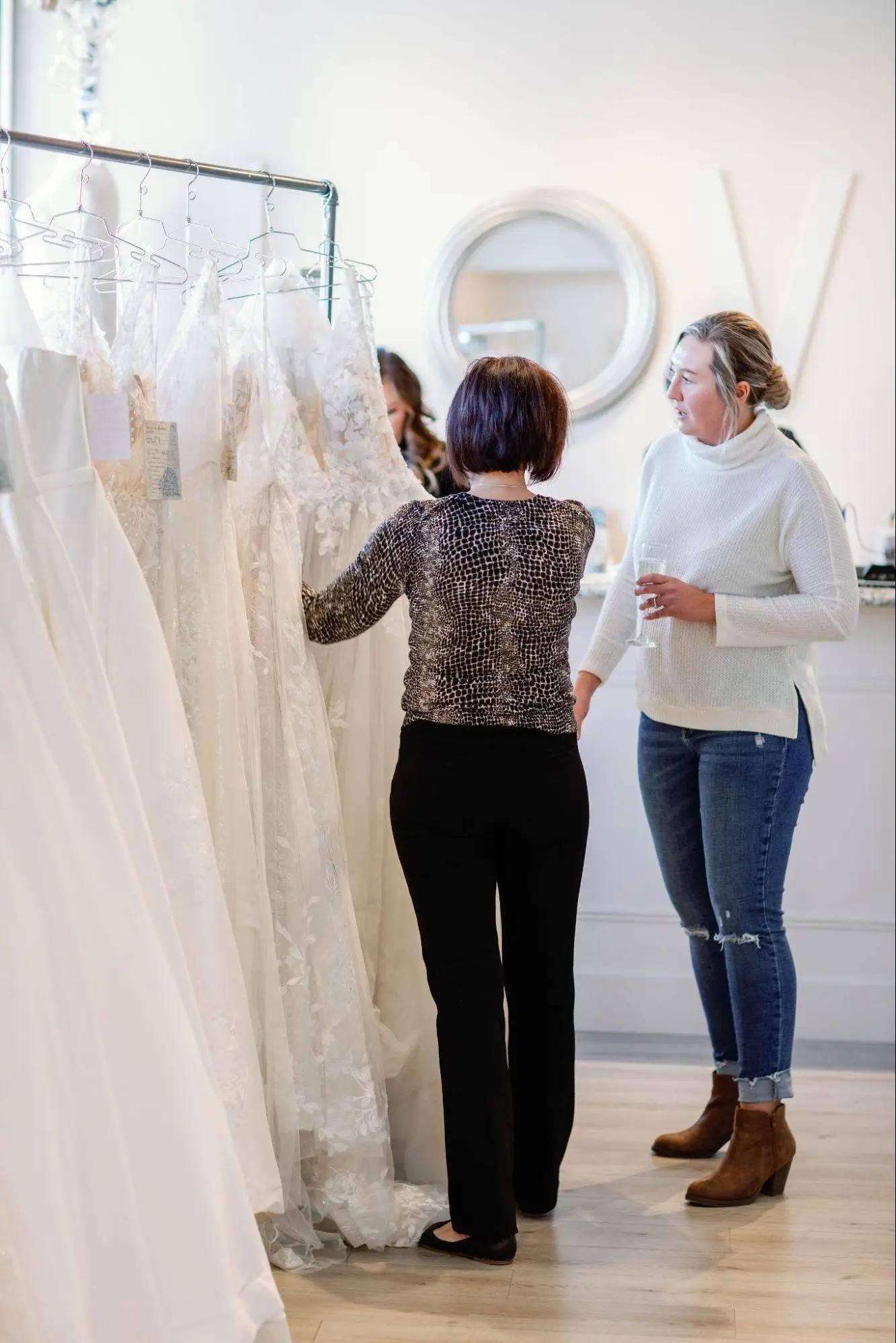 Belle Amour bride assisting bride in search of her wedding dress